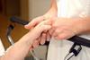 Nurse holding patient's hand